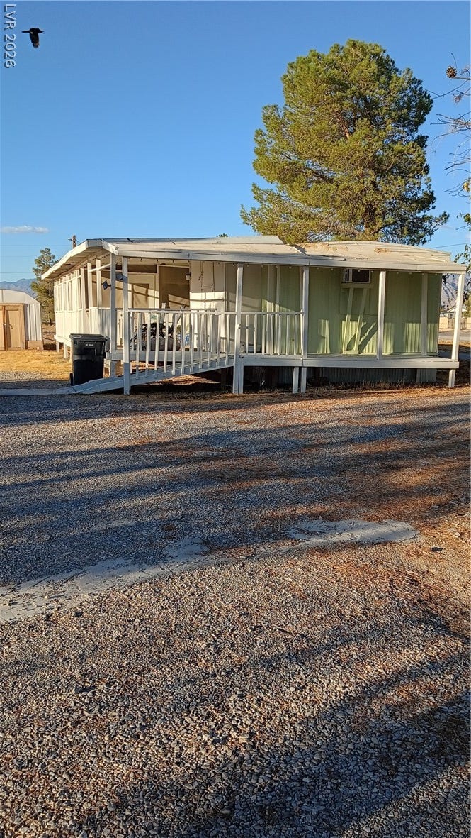 3490 E Savoy Boulevard, Pahrump, NV 89061 A spacious covered porch fronts this classic residence surrounded by mature trees.