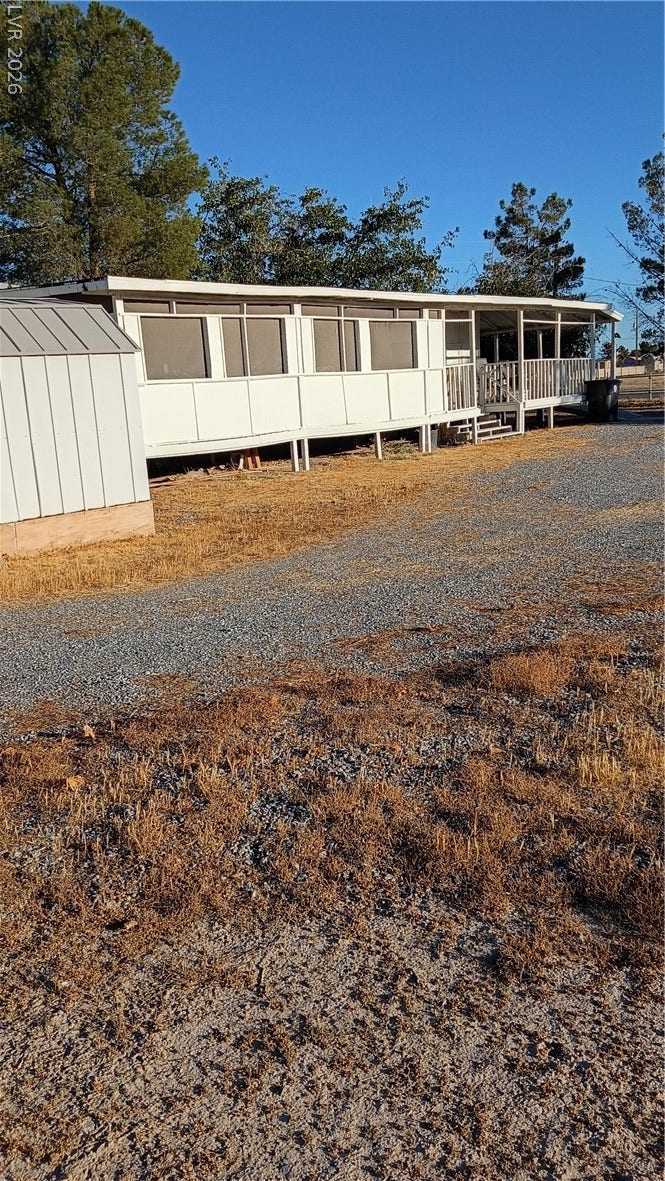 3490 E Savoy Boulevard, Pahrump, NV 89061 A spacious covered porch fronts this classic manufactured home on a sprawling gravel lot.