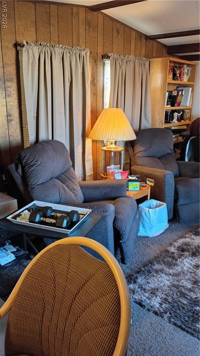 3490 E Savoy Boulevard, Pahrump, NV 89061 Warm wood-paneled walls and exposed ceiling beams create a cozy rustic retreat.