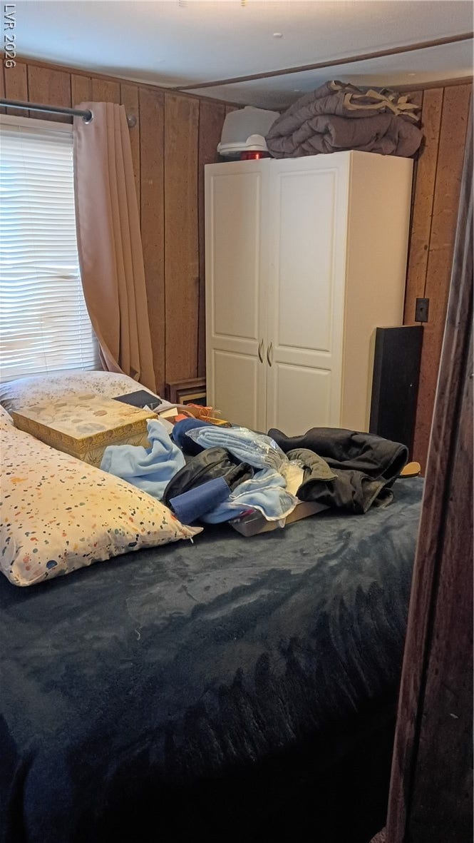 3490 E Savoy Boulevard, Pahrump, NV 89061 Rich wood paneling lines the walls of this cozy bedroom.