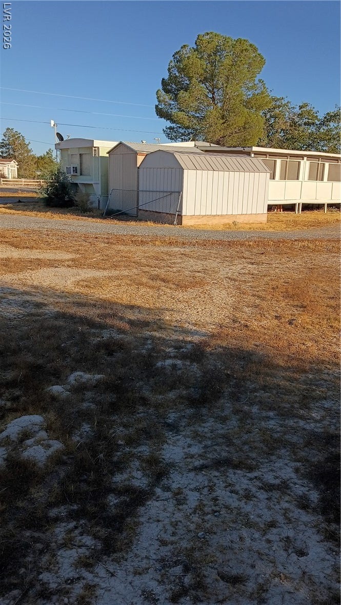 3490 E Savoy Boulevard, Pahrump, NV 89061 Functional outbuildings sit on an expansive lot surrounded by mature trees.