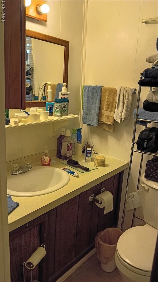 3490 E Savoy Boulevard, Pahrump, NV 89061 Functional bathroom space includes a single vanity paired with a framed mirror.