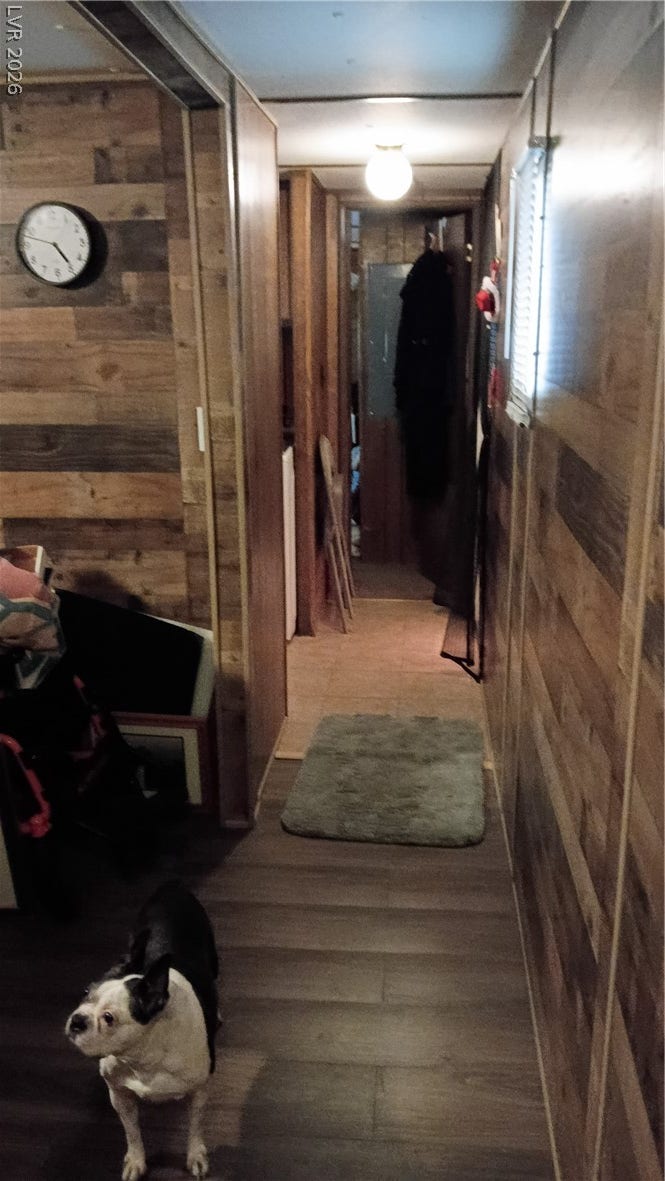 3490 E Savoy Boulevard, Pahrump, NV 89061 Rich wood plank walls create a warm, inviting atmosphere throughout this classic hallway layout.