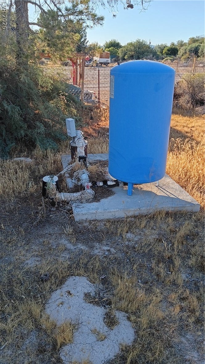 3490 E Savoy Boulevard, Pahrump, NV 89061 Essential utility equipment sits securely installed on a durable concrete pad within the yard.