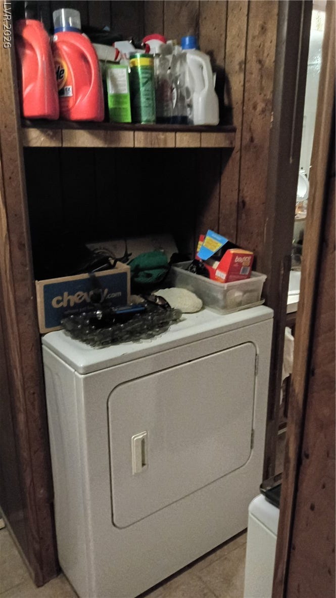 3490 E Savoy Boulevard, Pahrump, NV 89061 Wood paneling and built-in shelving maximize the utility of this dedicated laundry closet.