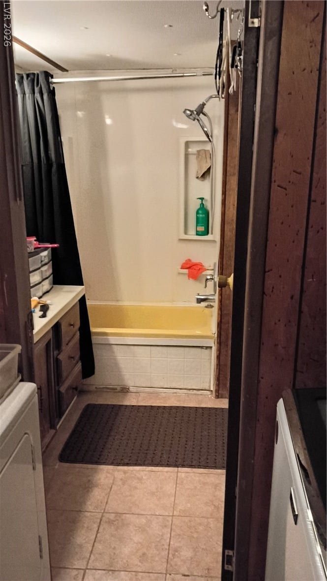 3490 E Savoy Boulevard, Pahrump, NV 89061 Tiled flooring and a classic tub shower combination define this functional bathroom layout.