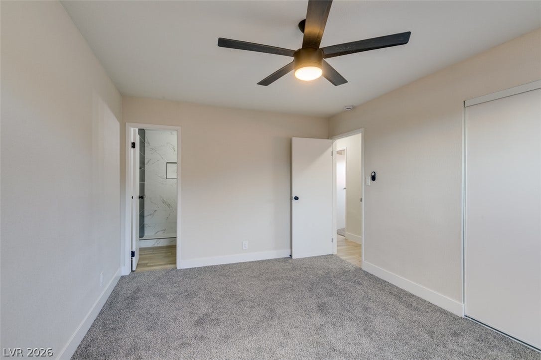 Soft carpeting underfoot anchors this quiet space featuring access to an adjacent private bath.