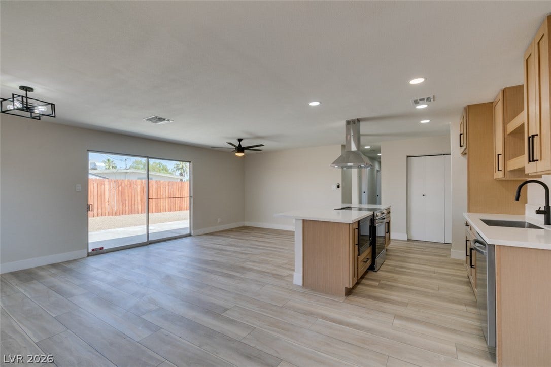 An open floorplan connects the modern kitchen seamlessly to the spacious living area.