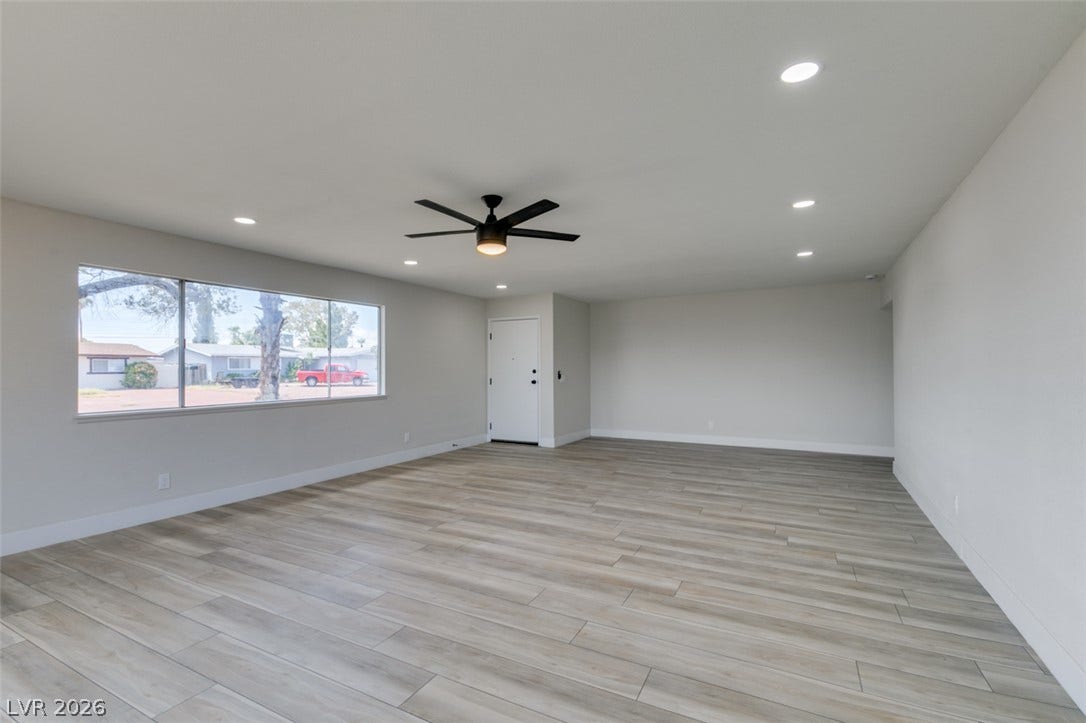 Smooth wood-look flooring and recessed lights define this airy interior layout.