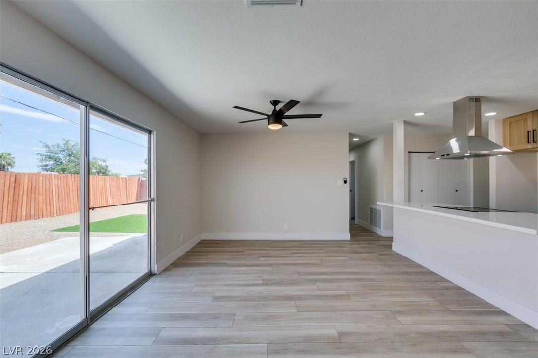 Sliding glass doors open from the main living area to a concrete patio outside.