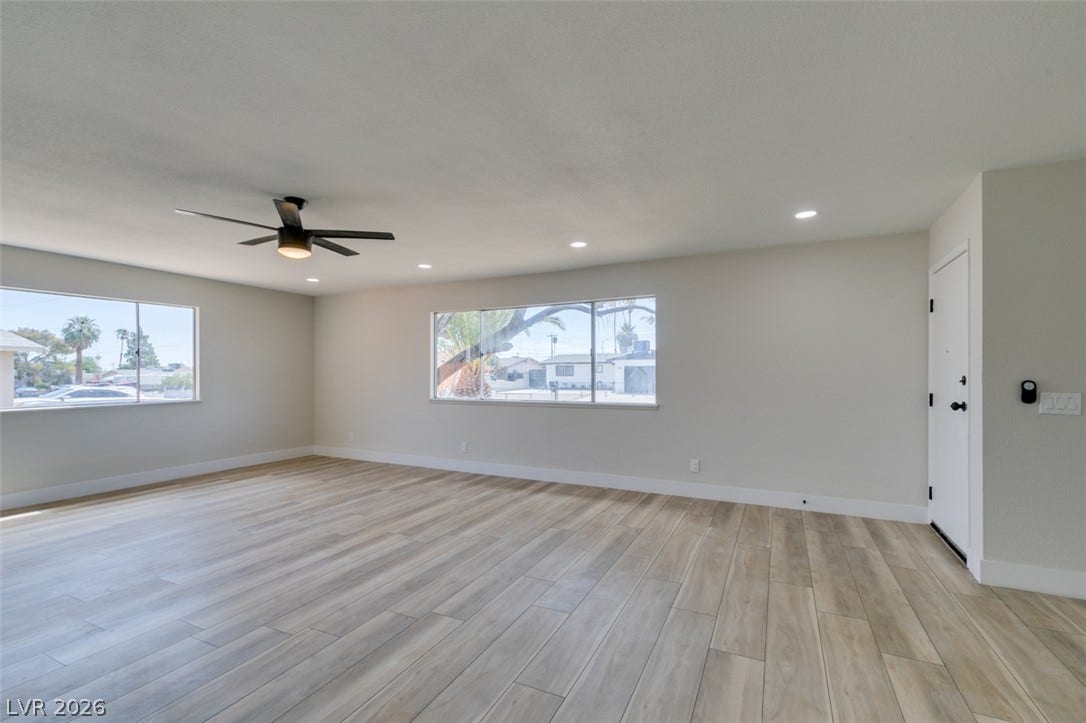 Clean lines and wood-look flooring define this open, light-filled living space.