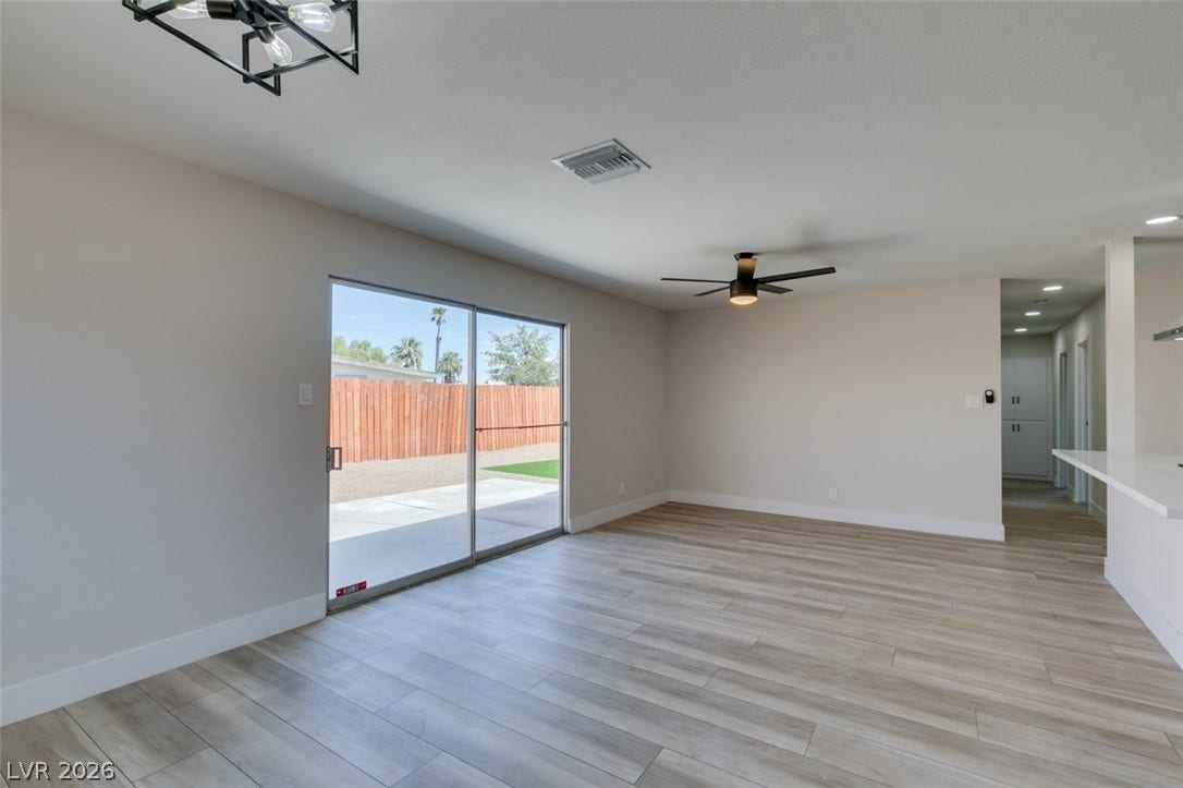 Sliding glass doors open directly to the backyard from this spacious living area.