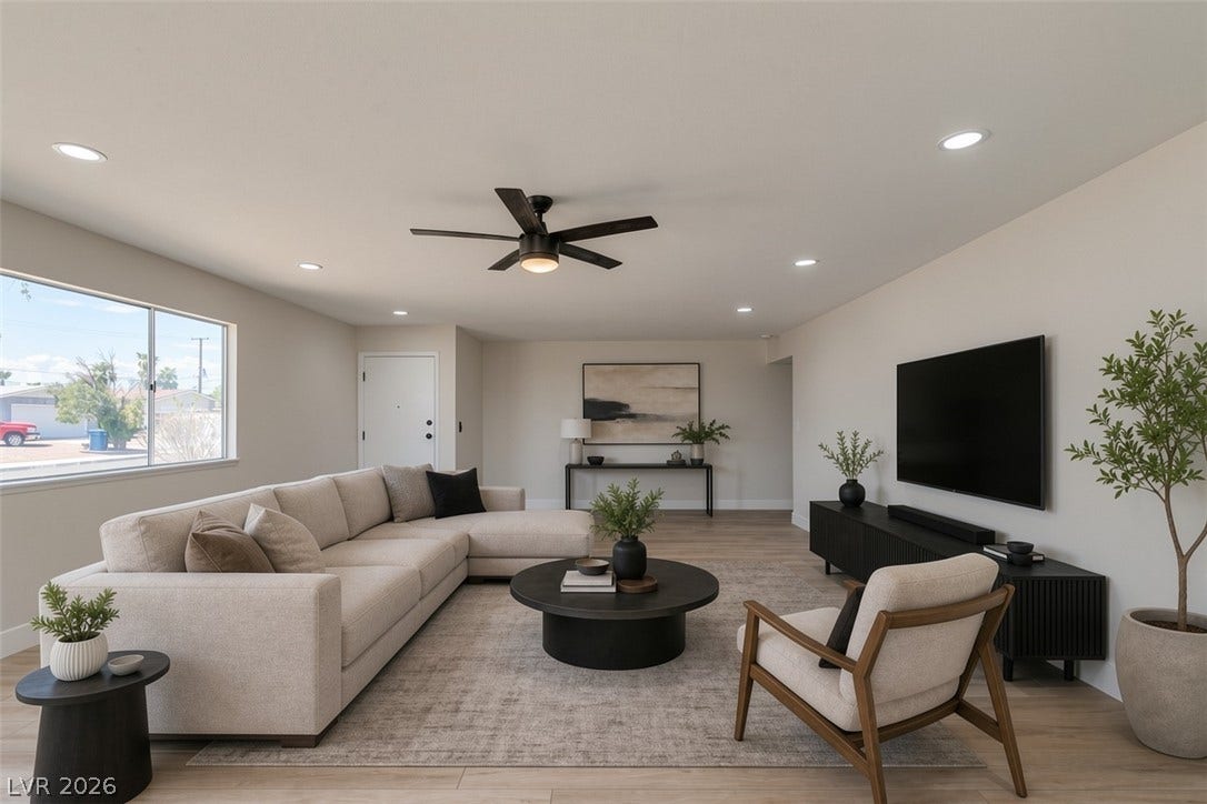 Virtually Staged Recessed lighting and warm wood-look floors anchor this spacious, open living area.