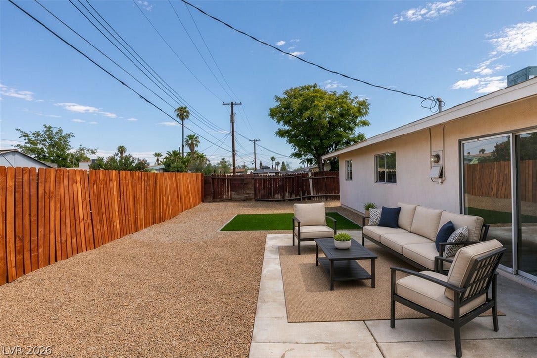 Virtually Staged An inviting concrete patio opens to a low-maintenance backyard enclosed by privacy fencing.