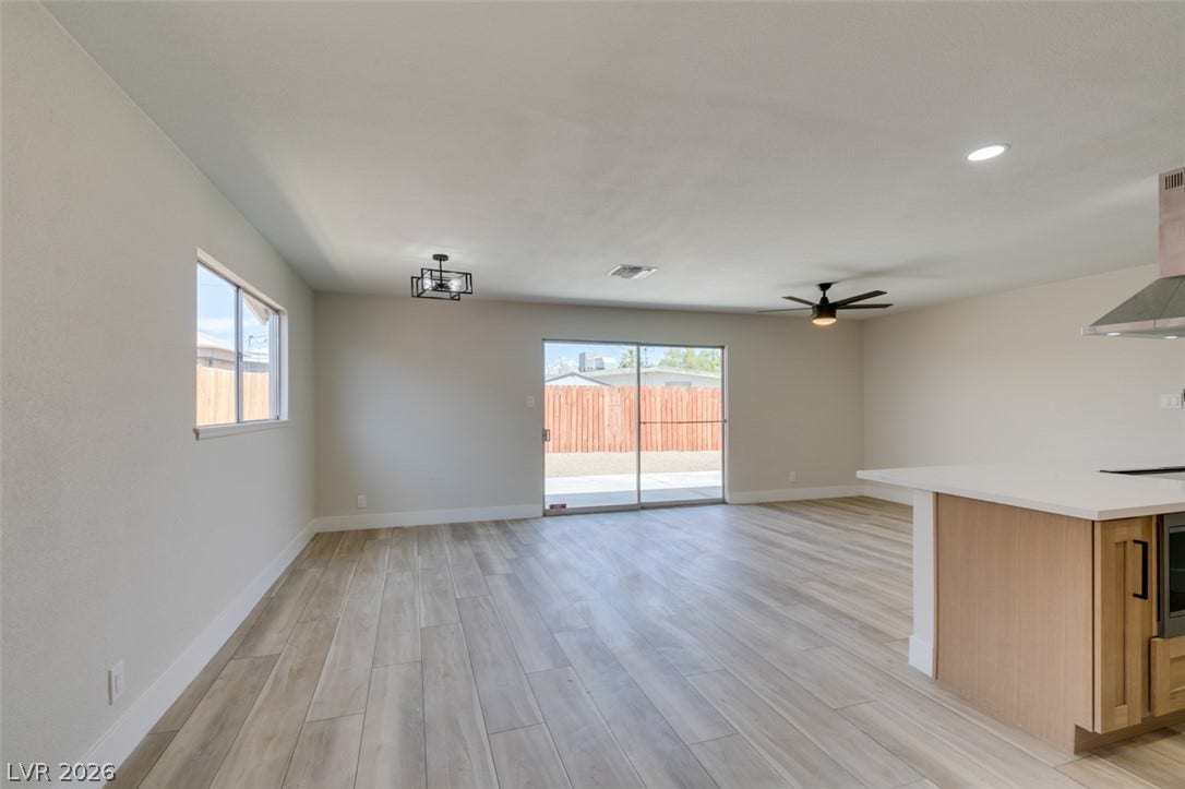 An open floor plan connects the kitchen to a versatile dining and living space.