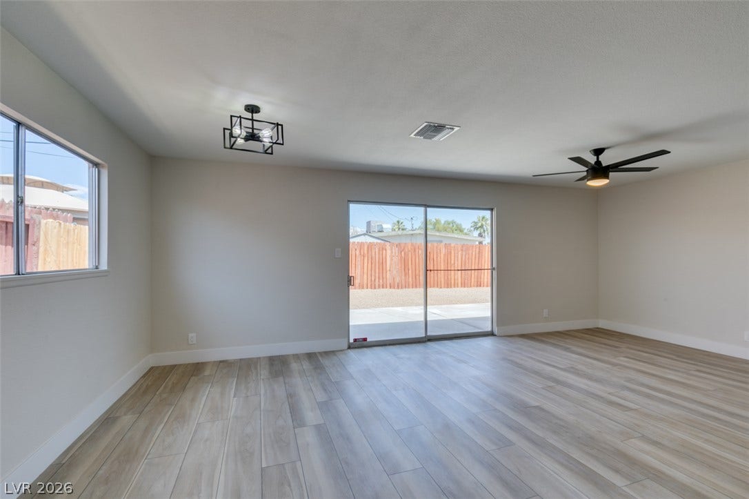 Sliding glass doors open directly to the backyard, connecting the living area to the outdoors.