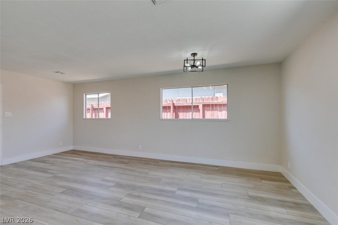 Clean lines and durable wood-look flooring define this versatile living space.