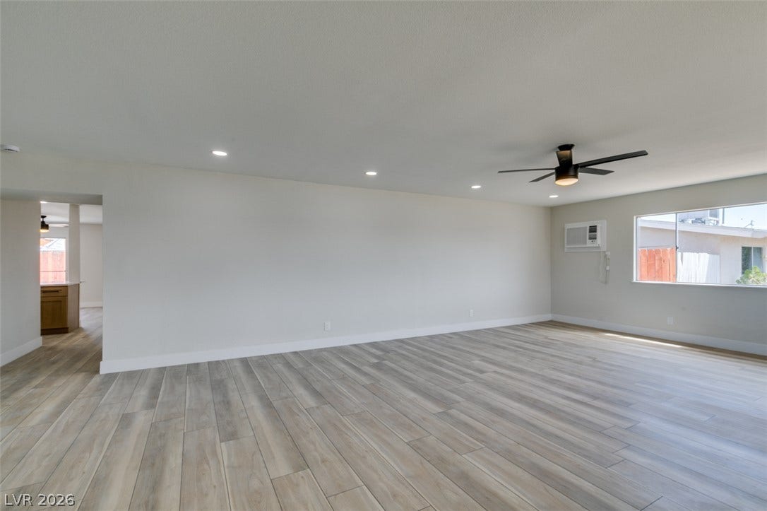 Smooth wood-look plank flooring anchors this versatile open living space.