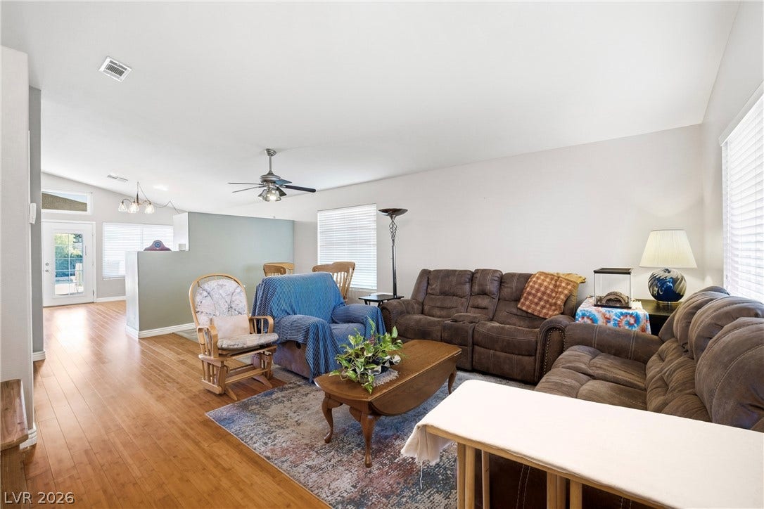 Gleaming hardwood floors flow throughout this spacious and airy open-concept living area.