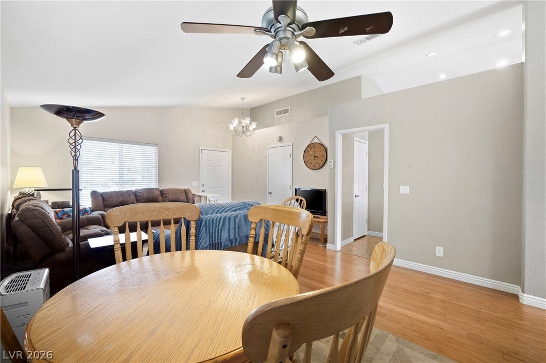 Warm wood flooring flows through this open concept floorplan under elevated vaulted ceilings.