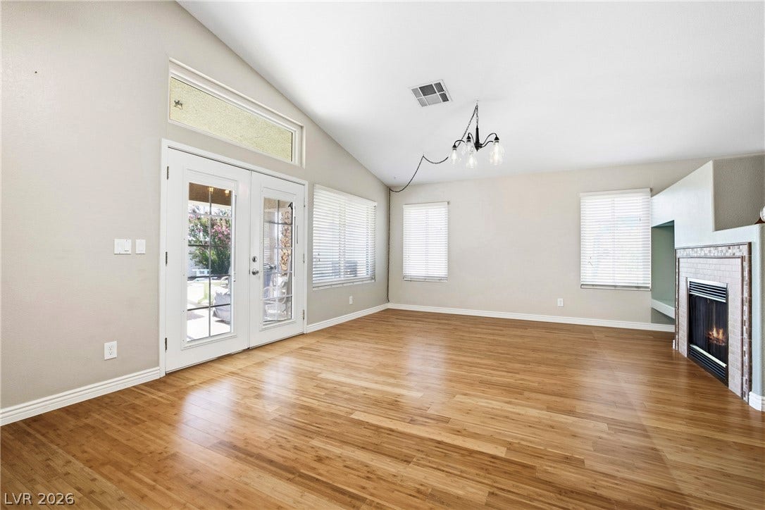 Rich wood flooring runs under soaring vaulted ceilings in this open, light-filled space.