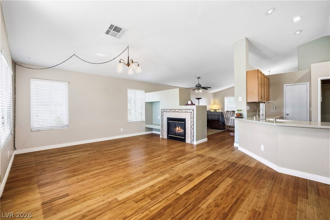 Gleaming hardwood floors flow throughout this airy open layout centered around a cozy fireplace.