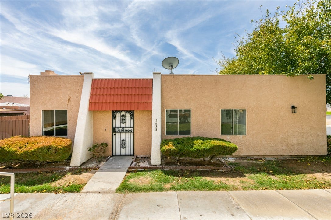 3638 Villa Knolls East Drive, Las Vegas, NV 89120 Mid-century architectural lines define this stucco single-story residence with a concrete walkway and landscaped front yard.