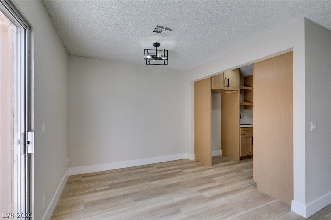 3638 Villa Knolls East Drive, Las Vegas, NV 89120 Wood-look flooring and crisp neutral walls define this versatile dining area adjacent to the kitchen.