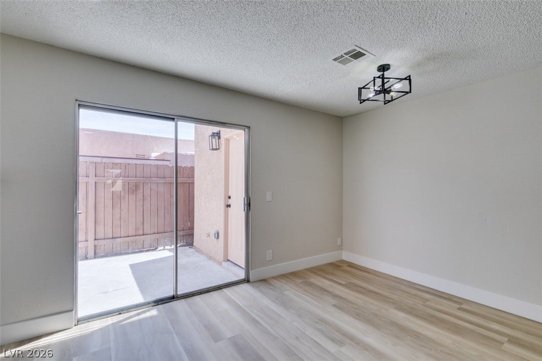 3638 Villa Knolls East Drive, Las Vegas, NV 89120 Sliding glass doors open directly to a private enclosed patio from this versatile room.