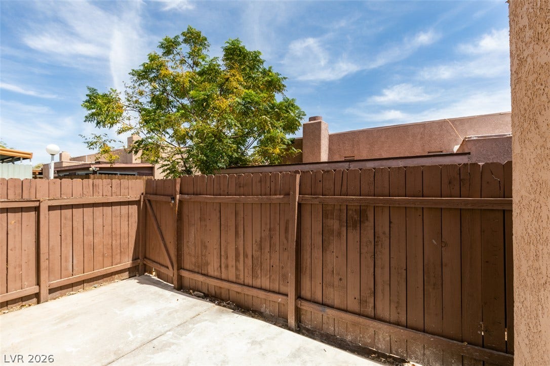 3638 Villa Knolls East Drive, Las Vegas, NV 89120 A private concrete courtyard enclosed by sturdy wooden fencing offers outdoor potential.