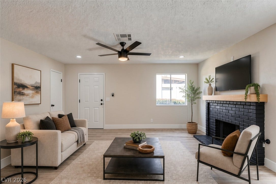 3638 Villa Knolls East Drive, Las Vegas, NV 89120 Virtually Staged Smooth wood floors anchor this inviting space featuring a dark brick fireplace.
