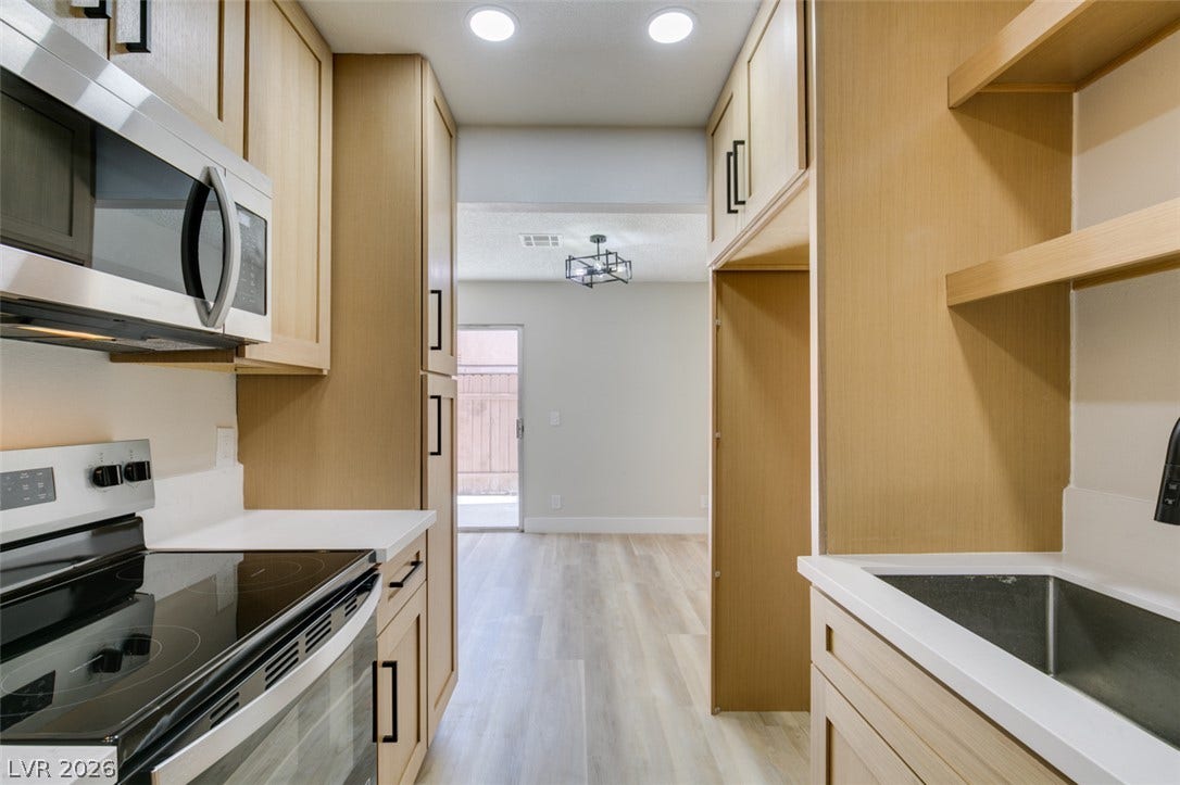 3638 Villa Knolls East Drive, Las Vegas, NV 89120 Streamlined cabinetry and clean countertops define this efficiently designed galley kitchen space.