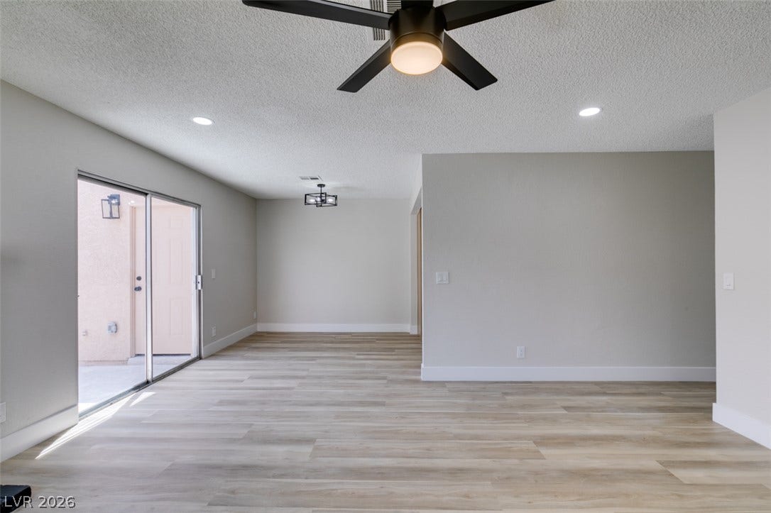 3638 Villa Knolls East Drive, Las Vegas, NV 89120 Sliding glass doors open from a spacious main living area featuring clean modern flooring.