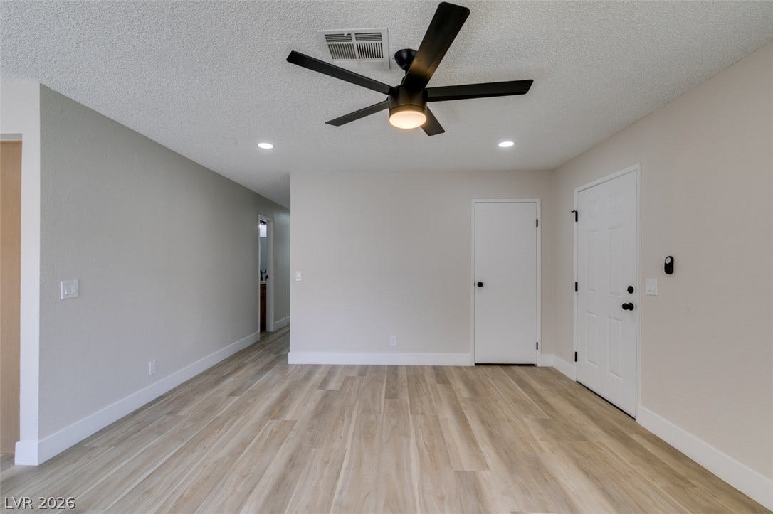 3638 Villa Knolls East Drive, Las Vegas, NV 89120 Smooth wood-look flooring and crisp recessed lighting set a modern tone in this versatile space.