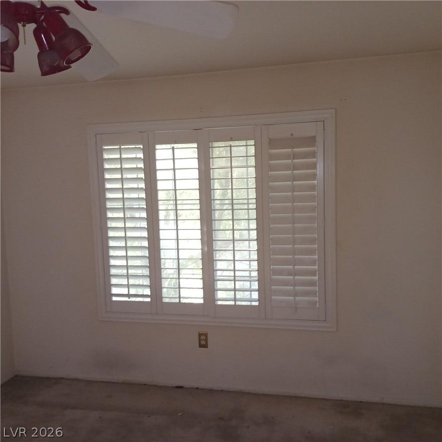 Classic plantation shutters grace a large window, filtering natural light into the space.