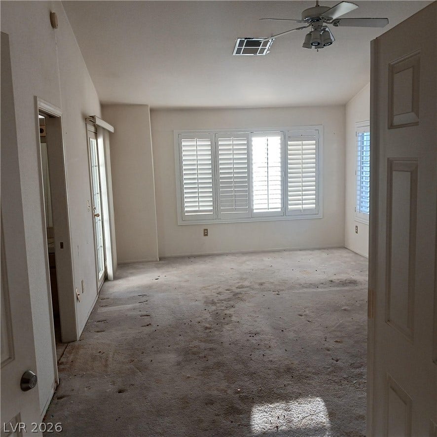 Vaulted ceilings and plantation shutters elevate this spacious primary bedroom.