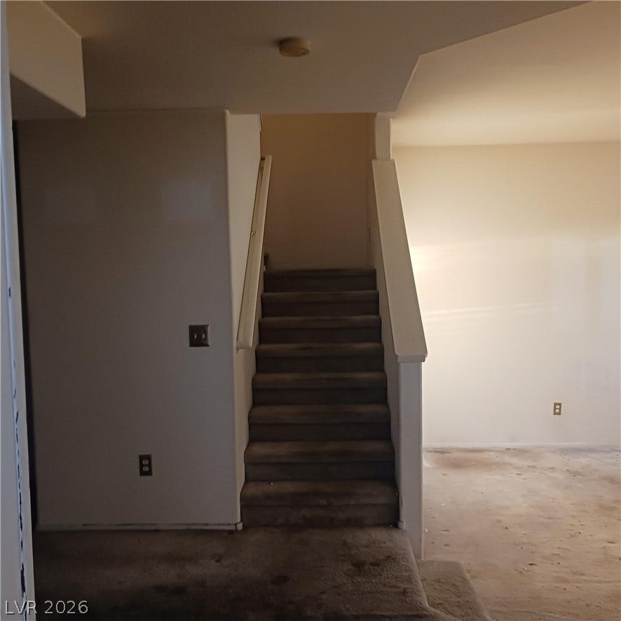 Carpeted stairs connect the different levels of this home.