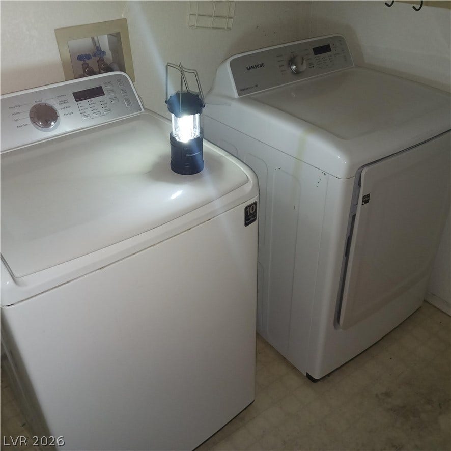 A dedicated laundry space features side-by-side washer and dryer units setup for daily convenience.