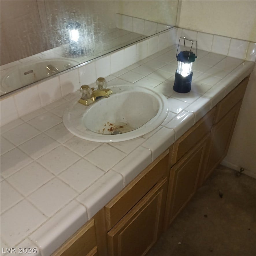 A spacious vanity area with built-in cabinetry awaits creative customization.