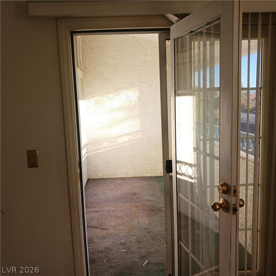 Glass doors open directly onto a private covered balcony.