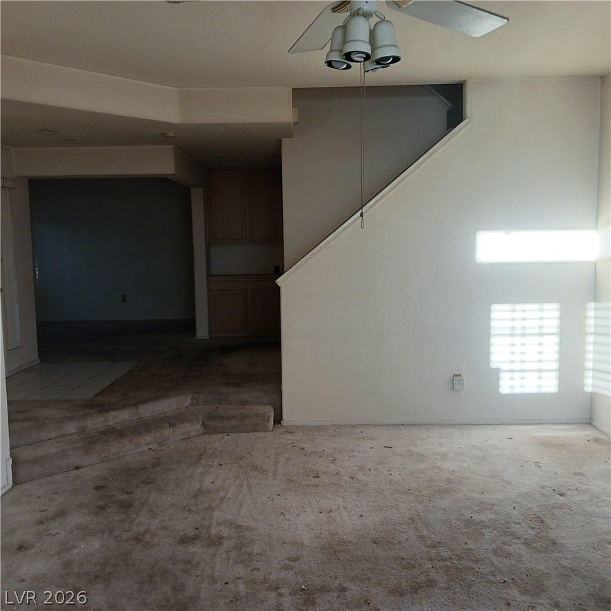 A spacious multi-level living area features a stepped floor plan and built-in cabinetry.
