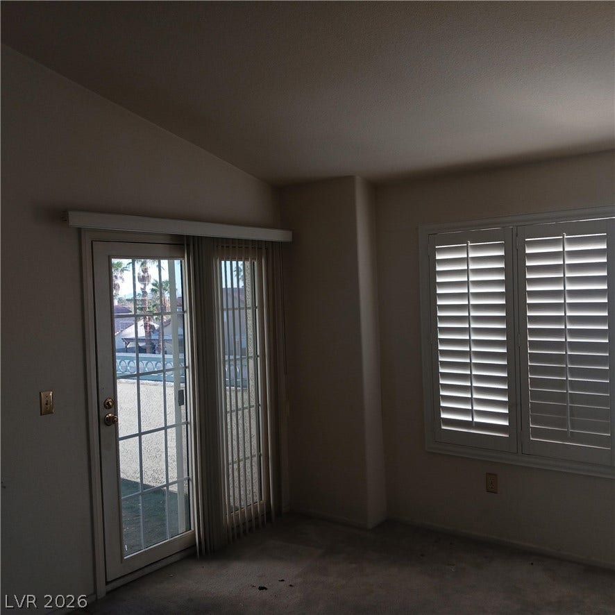 Vaulted ceilings and plantation shutters define this sunlit interior space opening to the outdoors.