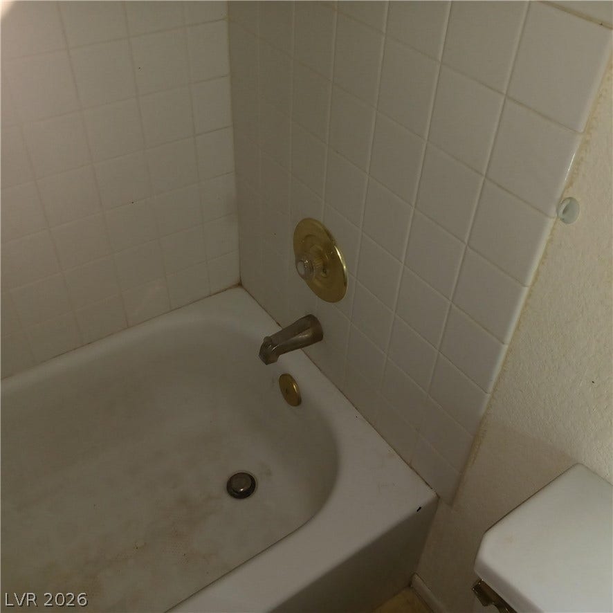 Classic tiled tub surround offers clean architectural lines ready for personal customization.