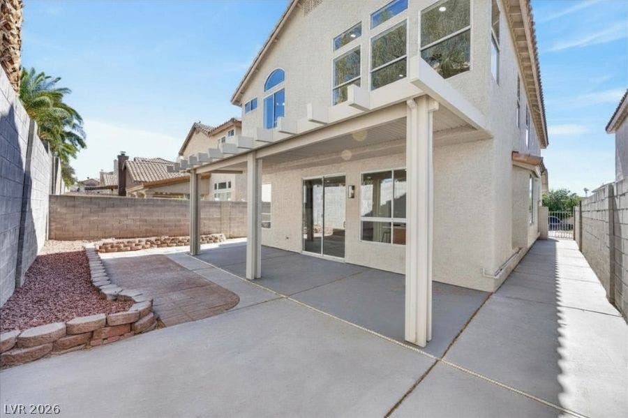 136 Villaggio Street, Henderson, NV 89074 An expansive covered patio provides shaded outdoor living space within a private walled backyard.