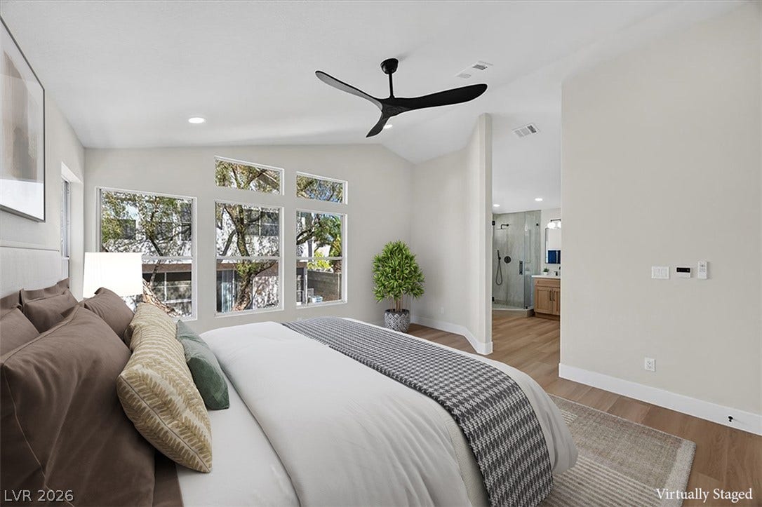 136 Villaggio Street, Henderson, NV 89074 Angled ceilings and tall windows bring architectural interest to this tranquil bedroom retreat.