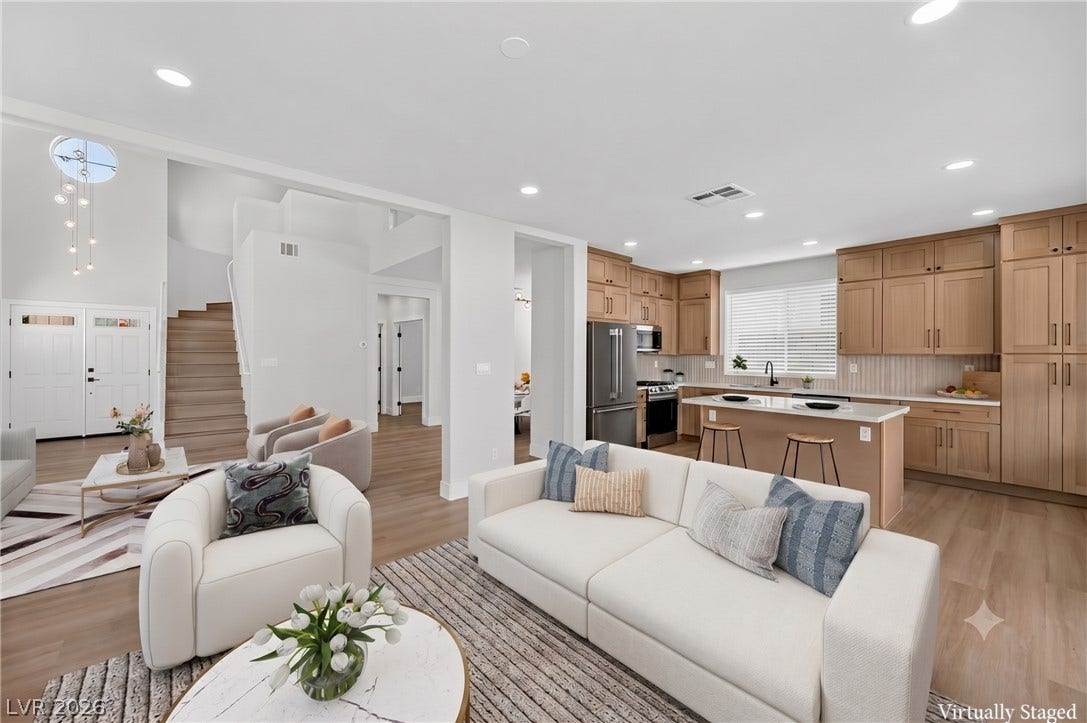 136 Villaggio Street, Henderson, NV 89074 Clean lines and warm wood tones define this airy open-concept living space and kitchen.