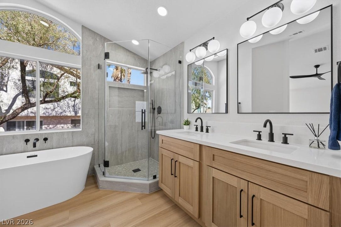 136 Villaggio Street, Henderson, NV 89074 An elegant main bath includes a freestanding soaking tub and a sleek double vanity.