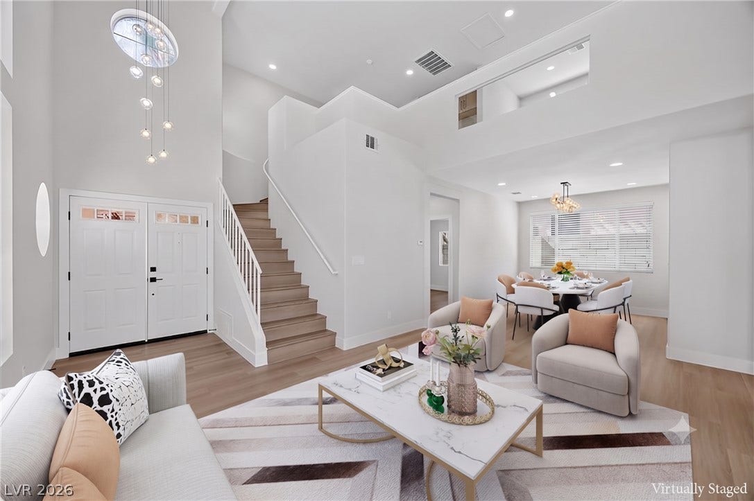136 Villaggio Street, Henderson, NV 89074 High ceilings and a modern open staircase define this light-filled entry and living area.