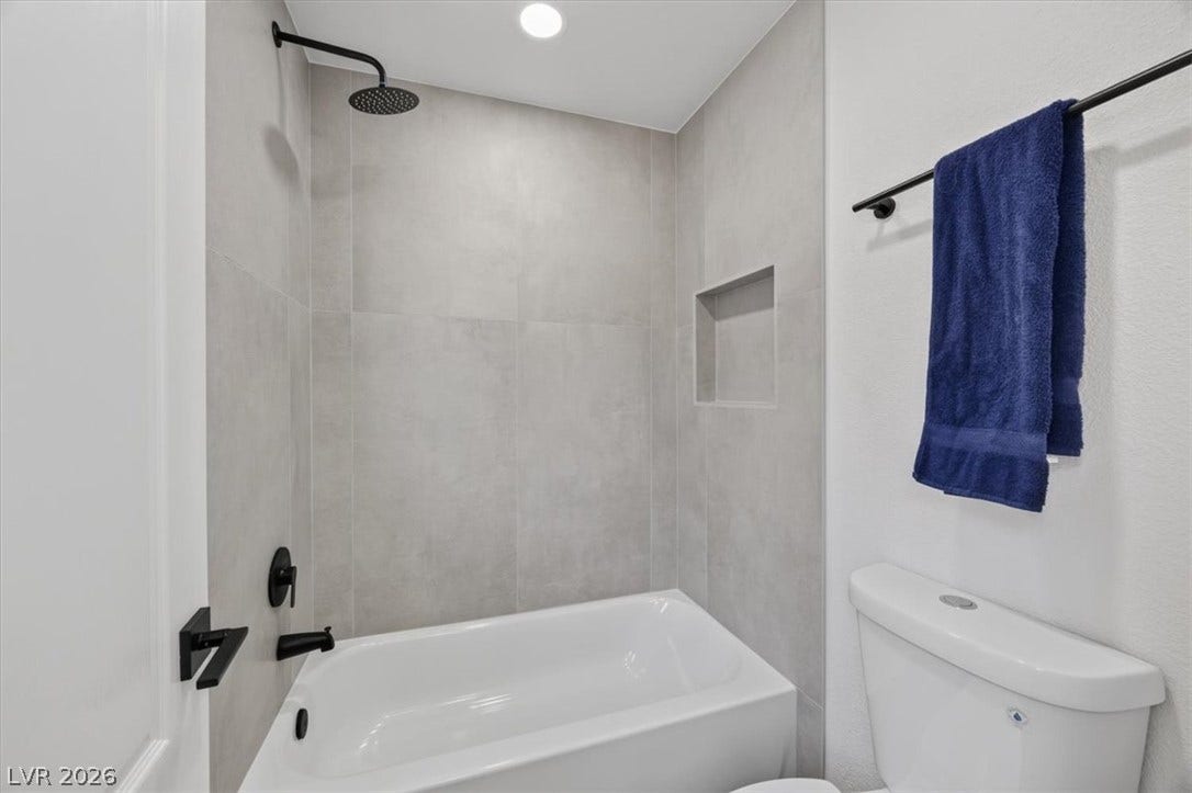 136 Villaggio Street, Henderson, NV 89074 Modern tile surrounds a deep soaking tub featuring matte black fixtures.