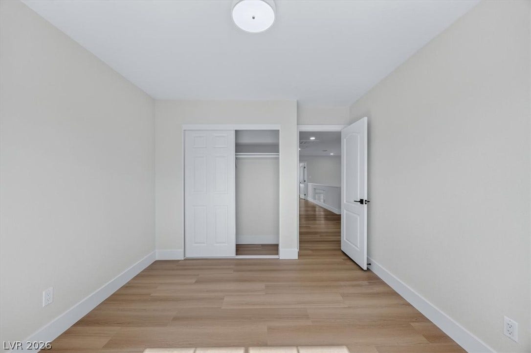 136 Villaggio Street, Henderson, NV 89074 Smooth wood floors and crisp neutral finishes define this serene bedroom space.
